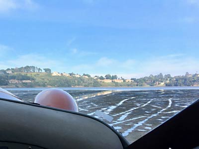 Seaplane taxiing on mud